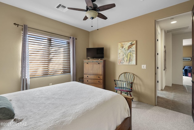 carpeted bedroom with visible vents and ceiling fan