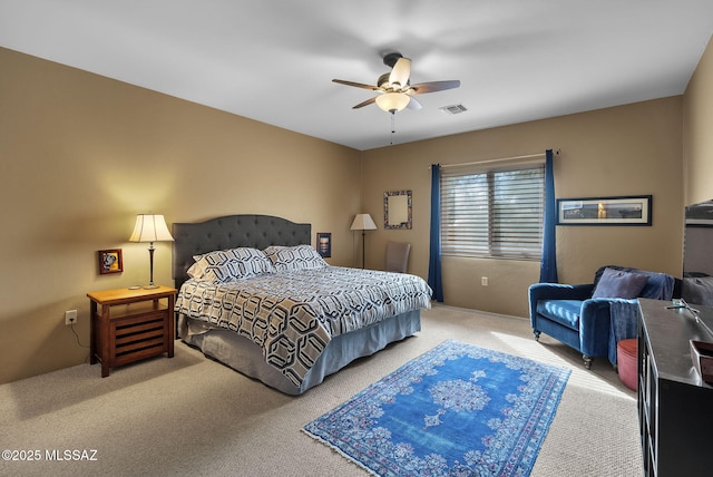 bedroom with carpet flooring, a ceiling fan, and visible vents