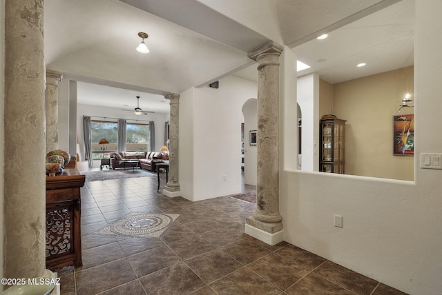 entrance foyer with arched walkways, dark tile patterned floors, ceiling fan, decorative columns, and recessed lighting
