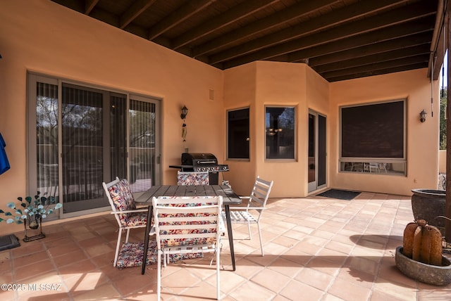 view of patio with outdoor dining area and a grill