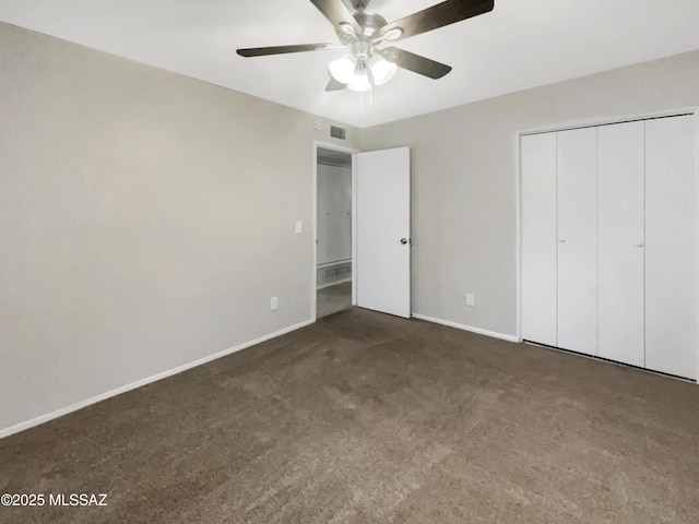 unfurnished bedroom featuring dark carpet, a closet, and ceiling fan