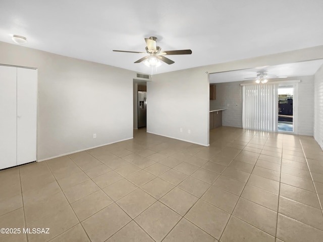 spare room with light tile patterned flooring and ceiling fan