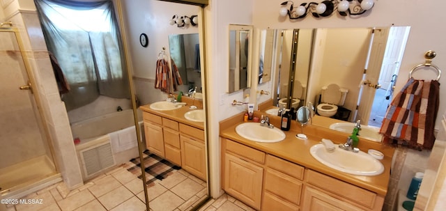 bathroom featuring tile patterned flooring, vanity, and shower with separate bathtub