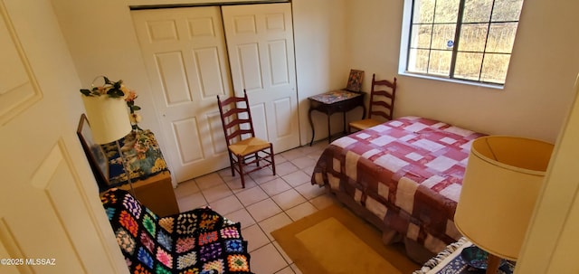 tiled bedroom featuring a closet