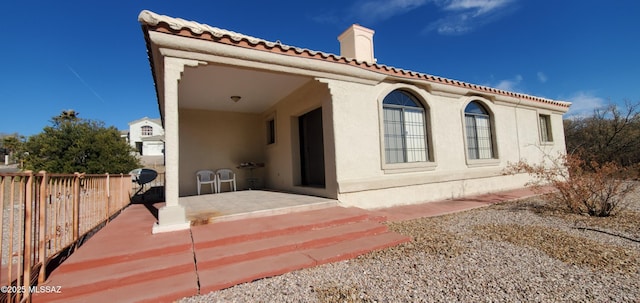 back of property with a patio