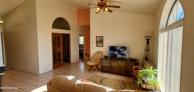 living room with high vaulted ceiling, ceiling fan, and light tile patterned flooring