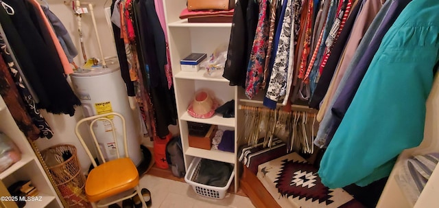 walk in closet with tile patterned floors and water heater