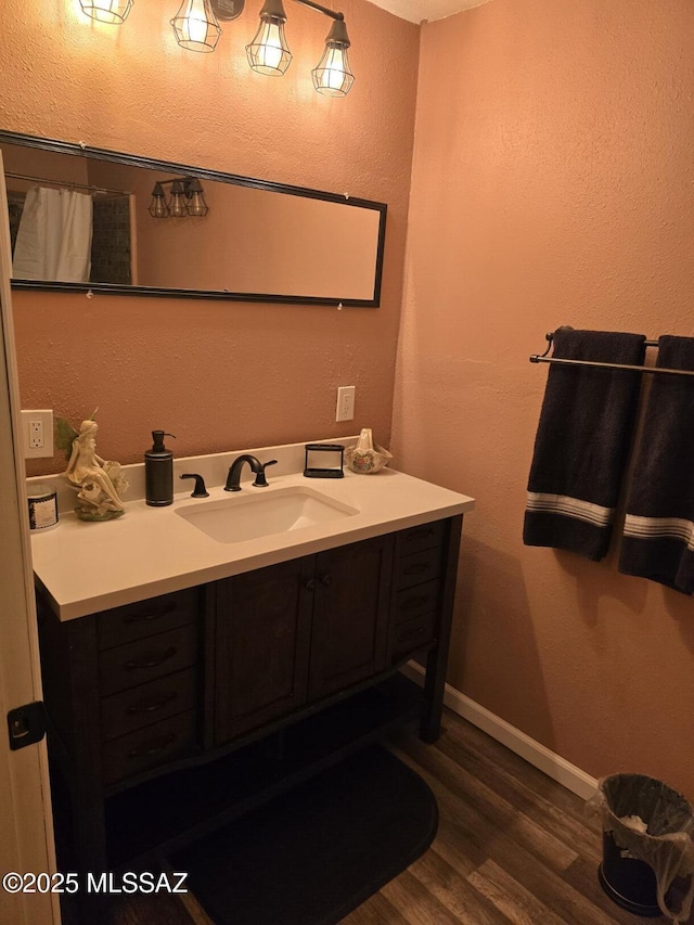 bathroom with vanity and hardwood / wood-style flooring