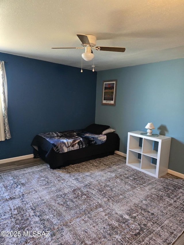 bedroom with a textured ceiling, carpet floors, and ceiling fan