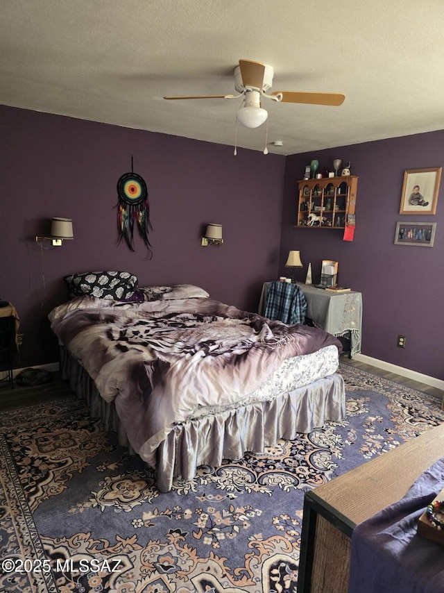 bedroom featuring ceiling fan and a textured ceiling