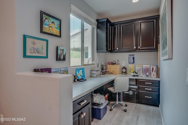 office featuring built in desk and light hardwood / wood-style floors