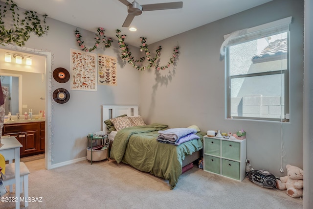 carpeted bedroom featuring ensuite bath and ceiling fan