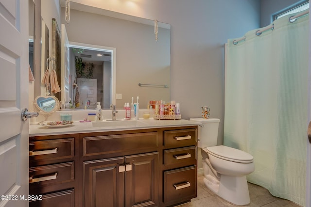 bathroom featuring tile patterned flooring, vanity, and toilet