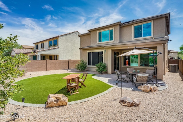 rear view of property with central AC, a patio, and a lawn