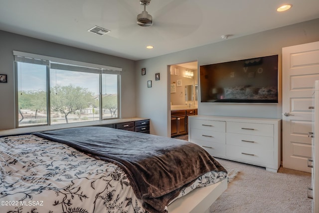 carpeted bedroom featuring ensuite bathroom