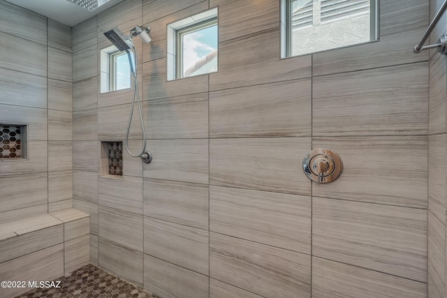 bathroom featuring tiled shower