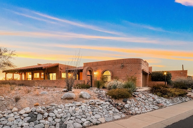 pueblo revival-style home featuring a garage