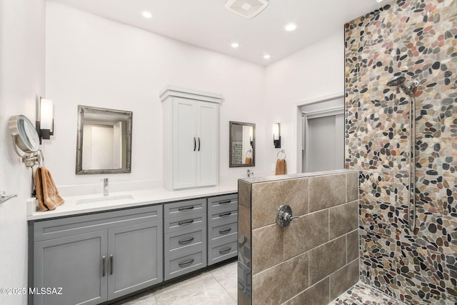 bathroom featuring vanity, tile patterned floors, and tiled shower