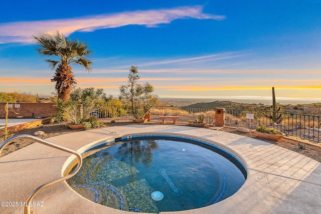 pool at dusk featuring a patio area