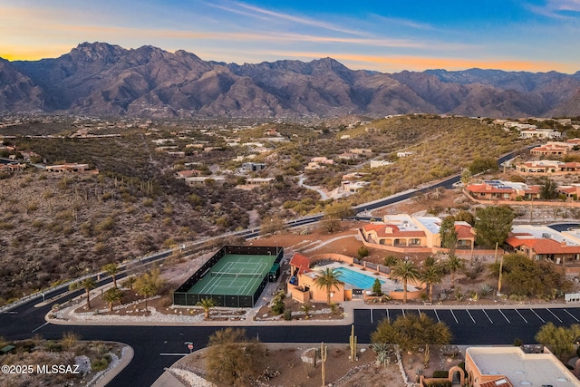 aerial view at dusk featuring a mountain view