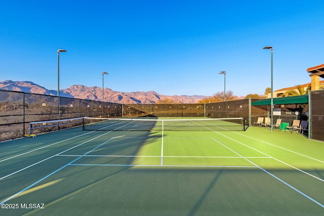 view of sport court featuring a mountain view and basketball court