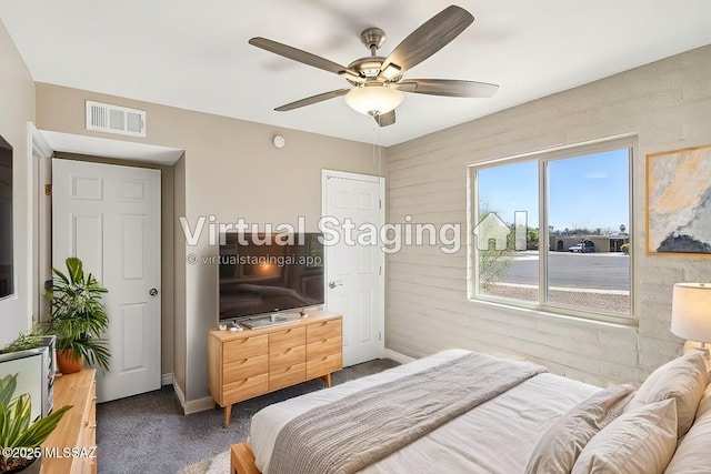 carpeted bedroom featuring a ceiling fan, baseboards, and visible vents