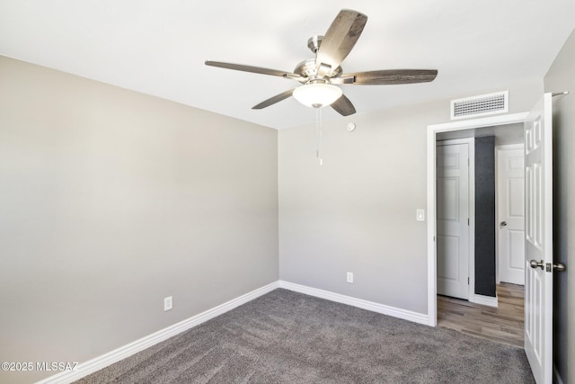 unfurnished bedroom featuring baseboards, a ceiling fan, visible vents, and carpet