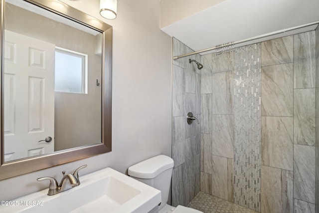 2572 W Calle Genova, Tucson, AZ 85745 - bathroom featuring a sink, toilet, and tiled shower