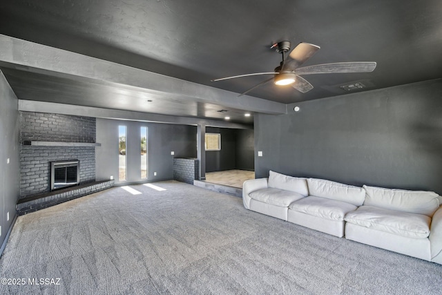 unfurnished living room with a ceiling fan, visible vents, carpet, and a brick fireplace