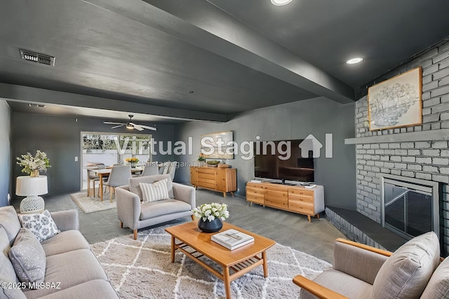 carpeted living room featuring visible vents, a ceiling fan, and a brick fireplace