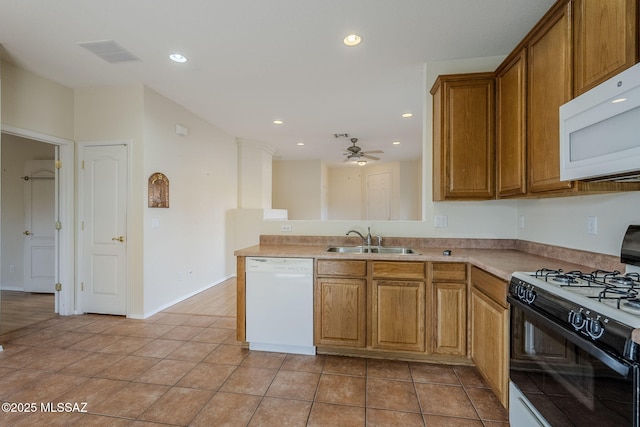 kitchen featuring light tile patterned flooring, sink, ceiling fan, kitchen peninsula, and white appliances