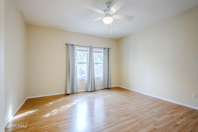 spare room featuring ceiling fan and light wood-type flooring