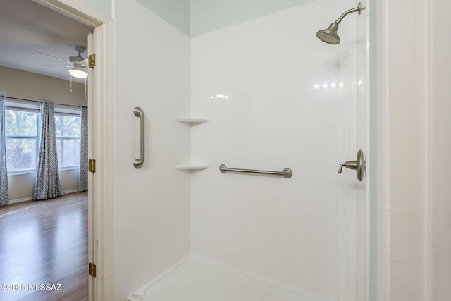 bathroom with hardwood / wood-style flooring, ceiling fan, and walk in shower