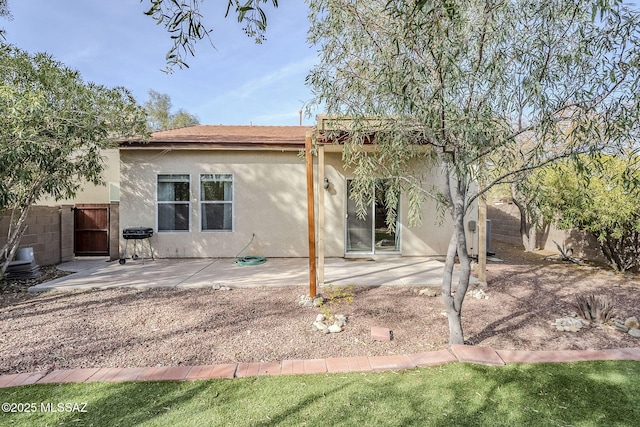 back of property with a patio