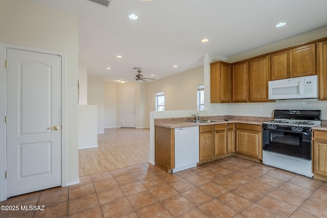 kitchen featuring ceiling fan, white appliances, sink, and light tile patterned floors