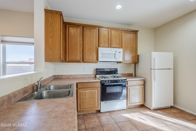 kitchen with light tile patterned flooring, white appliances, and sink