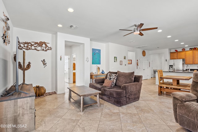 living area featuring ceiling fan, visible vents, and recessed lighting