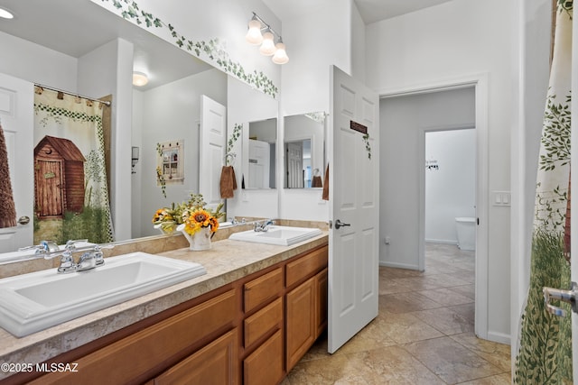 bathroom featuring a sink and double vanity