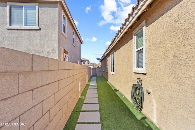 view of property exterior featuring a fenced backyard and stucco siding