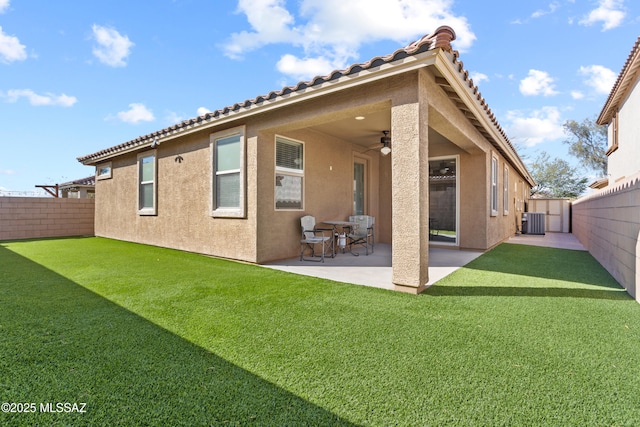 back of house with cooling unit, a fenced backyard, and stucco siding