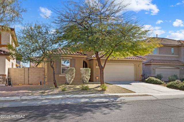 view of front of home with a tile roof, driveway, fence, and stucco siding