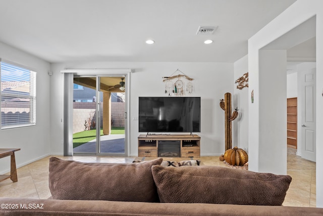 living area featuring light tile patterned floors, baseboards, visible vents, and recessed lighting