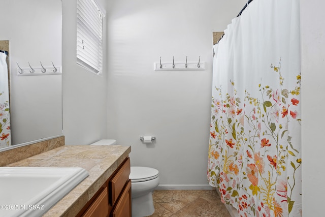 bathroom featuring toilet, a shower with curtain, baseboards, and vanity