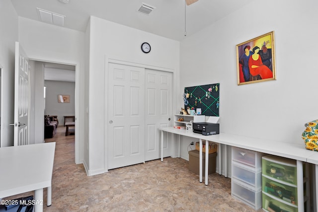 home office with stone finish flooring and visible vents