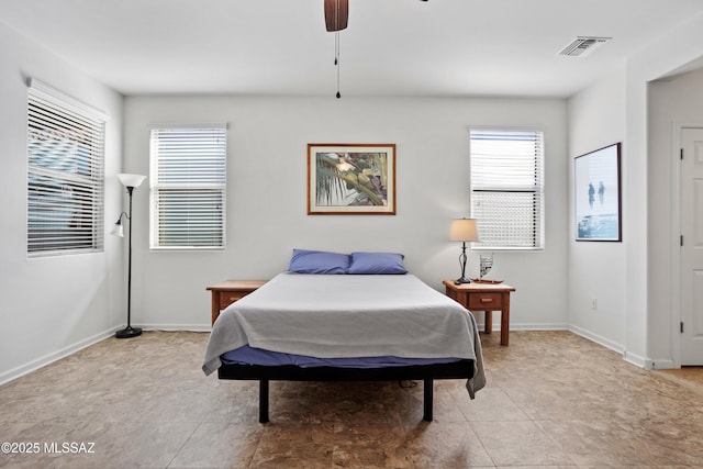 bedroom featuring ceiling fan, light tile patterned flooring, visible vents, and baseboards