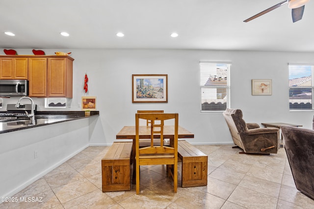 dining space with baseboards, a ceiling fan, and recessed lighting