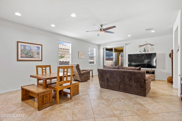 living room featuring ceiling fan, visible vents, baseboards, and recessed lighting