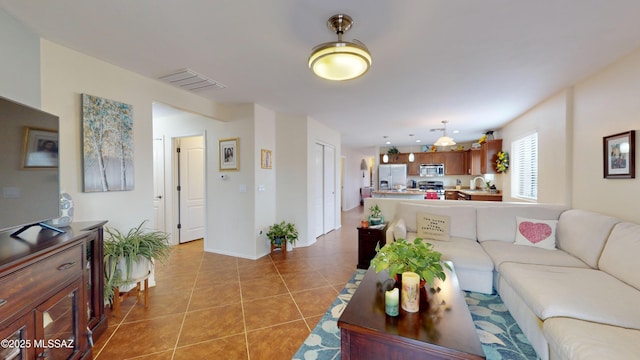 tiled living room featuring sink