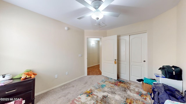 carpeted bedroom with a closet and ceiling fan