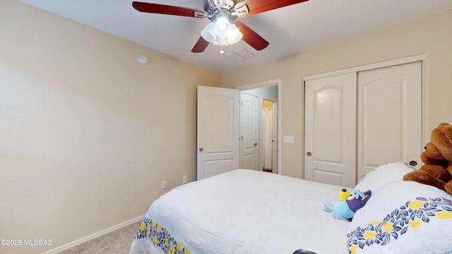 carpeted bedroom featuring a closet and ceiling fan